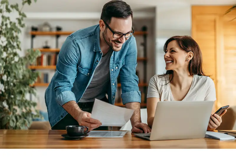 Two owners reading offers with somebody whose job it is.